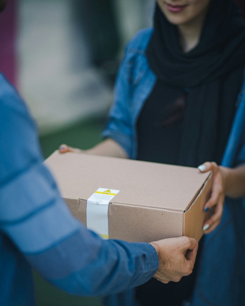 A parcel passing from one pair of hands to another, sealed and labelled