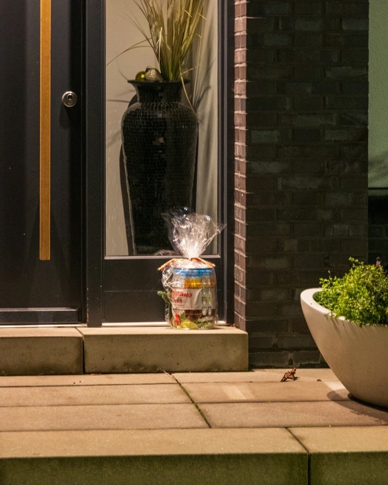 A wrapped parcel waiting on a lit doorstep, left exactly where the buyer asked